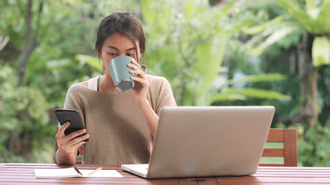 Customer using a phone and laptop to manage a rental